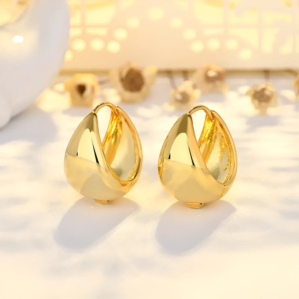 Copper geometric circle ear clips with gold inlay, ellipse and ring shape, shown in gold or white colour options.