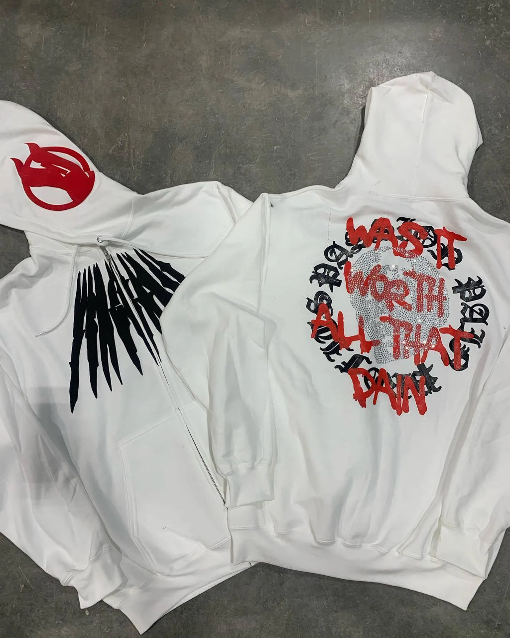 Black hooded sweatshirt with white skull pattern and rhinestone detailing