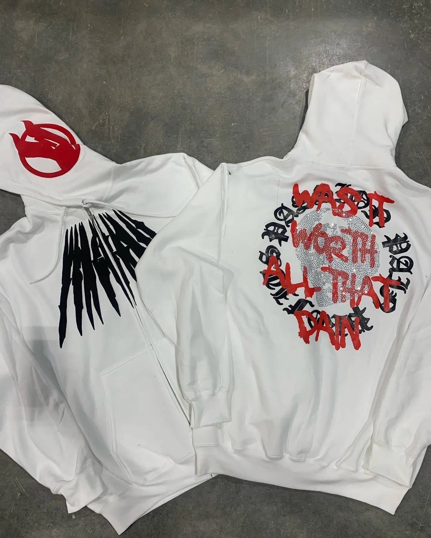 Black hooded sweatshirt with white skull pattern and rhinestone detailing
