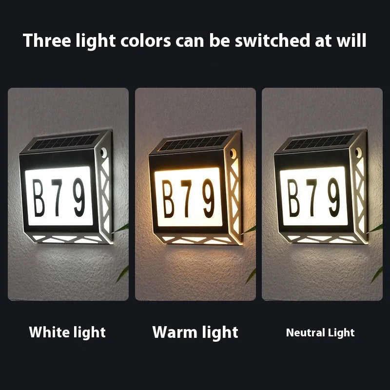Black solar powered waterproof doorplate light with LED house numbers mounted on exterior wall