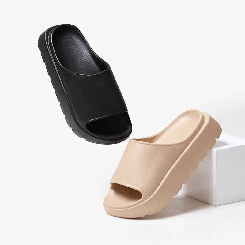 Women's beige EVA fish mouth slippers with a thick 5.5cm sole on a tiled floor.