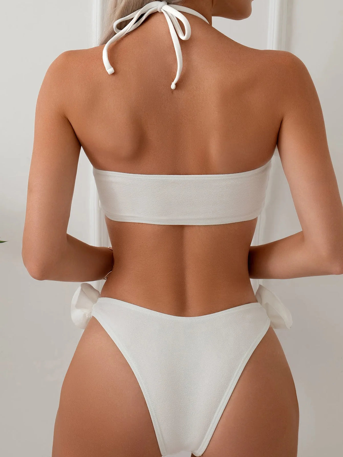 White split swimsuit with three-dimensional flower, halter lace-up neck, and briefs style, sizes S M L