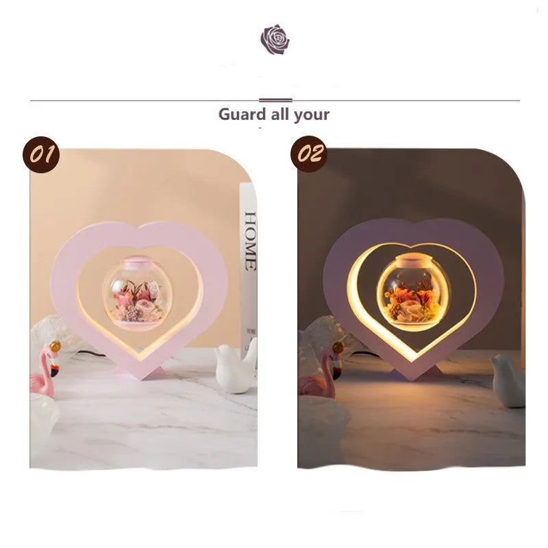 Pink preserved rose ornament gift with optional Bluetooth audio base on a wooden table.