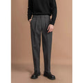 Man wearing straight-fit suit pants in a draped silhouette, suitable for business and casual occasions.