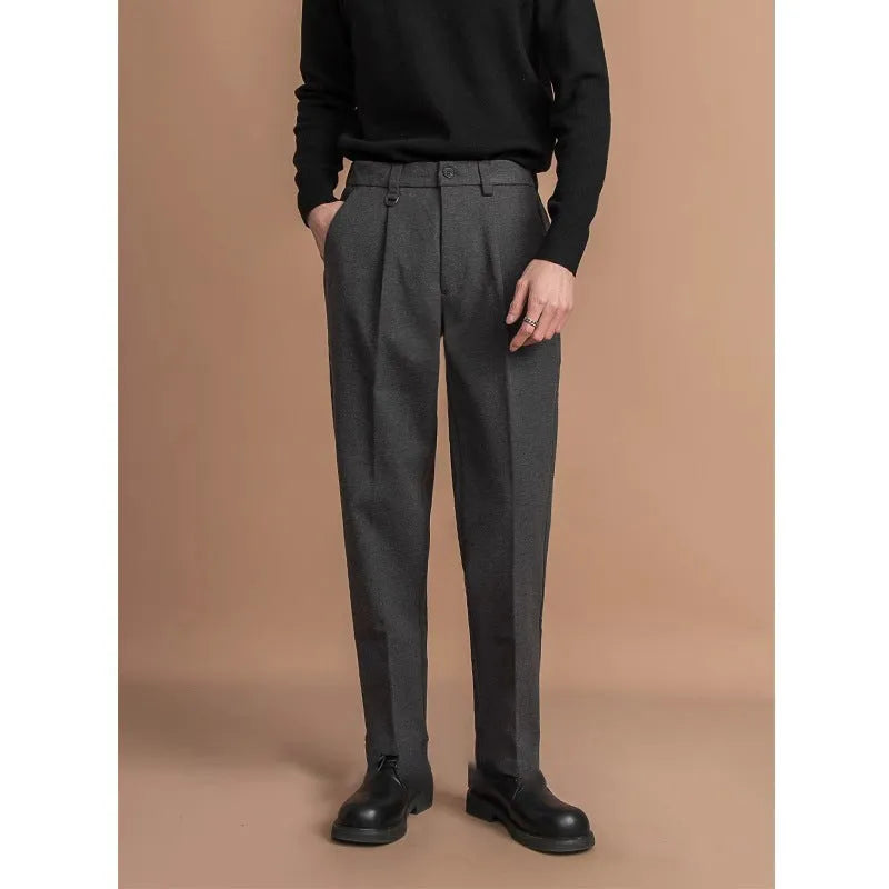 Man wearing straight-fit suit pants in a draped silhouette, suitable for business and casual occasions.