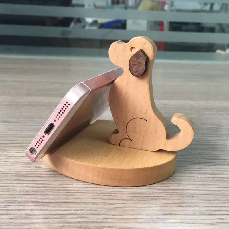 Beech wood mobile phone holder with coin slot in animal design style on wooden desk