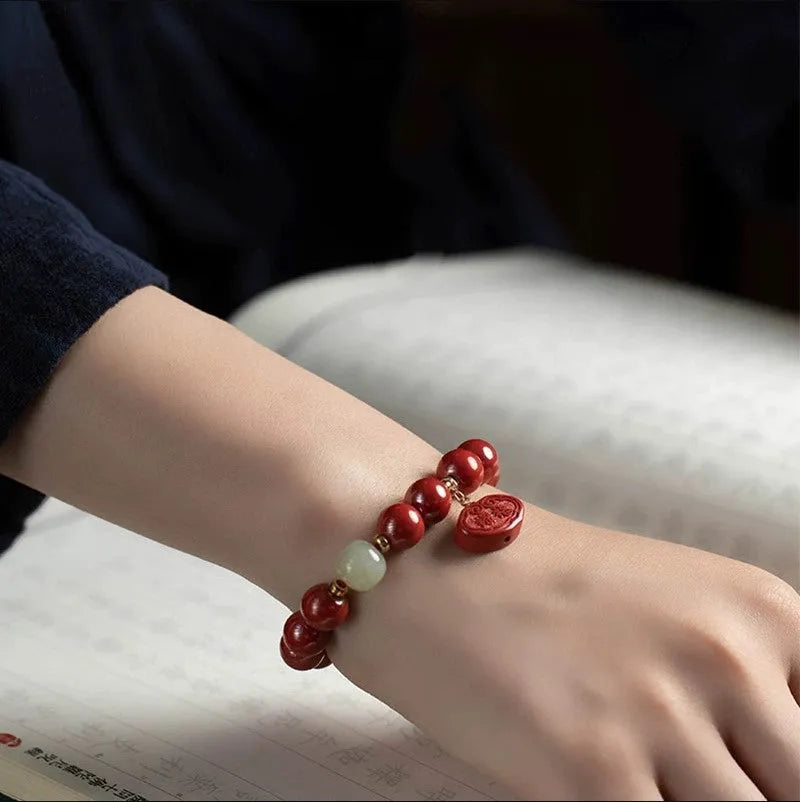 Red cinnabar bracelet with Ping An Fu Lu design in Emperor sandstone style showing 8mm and 10mm size options