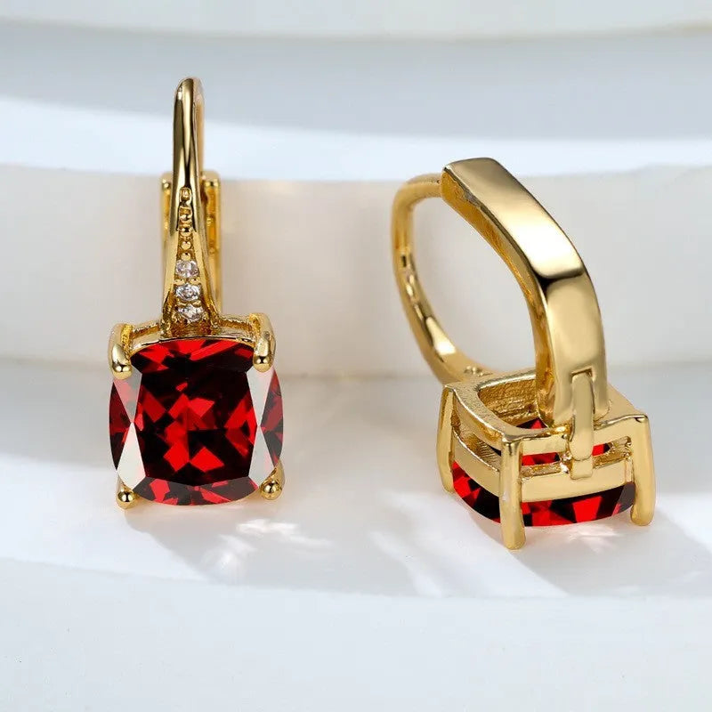 Geometric copper ear hook earrings with a round square zircon inlay, shown in a gold electroplated finish.