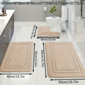 Three-piece PVC bathroom floor mat set in grey with striped and grid patterns on tiled floor