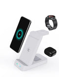 Black and white 3-in-1 wireless charging station showing phone in stand mode, with spaces for AirPods and Apple Watch.