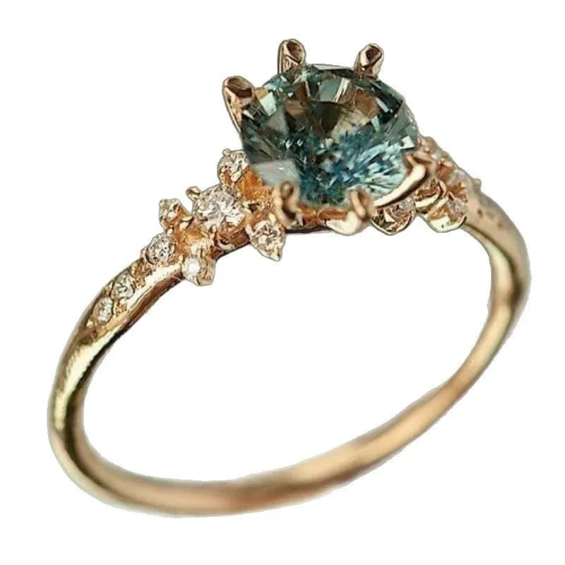 Gold plated geometric ring with claw inlay zircon stones and a chamfered square pattern.