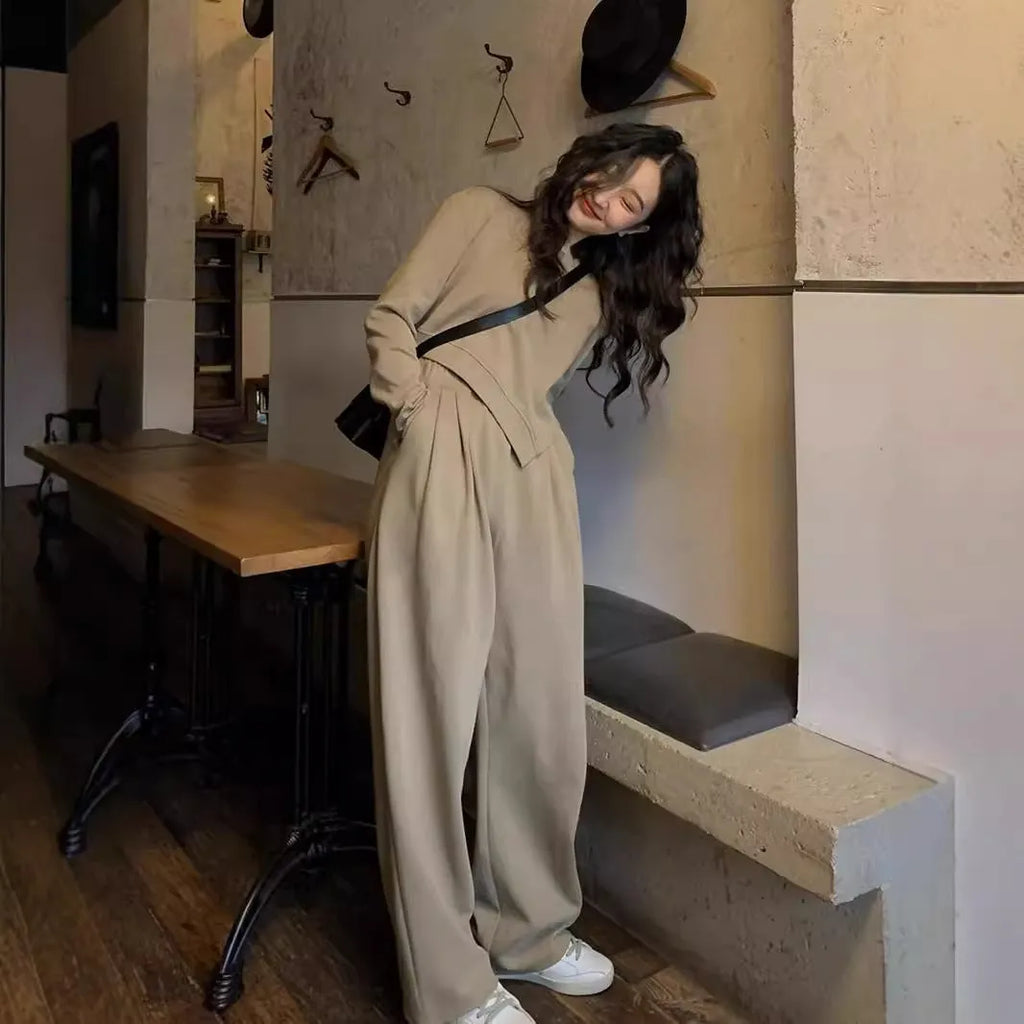 Women's khaki loose-fit casual sportswear set with long sleeve top and trousers on a hanger.