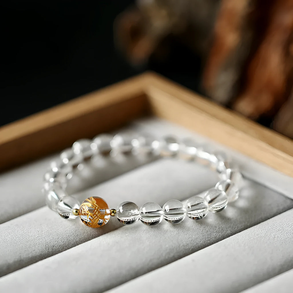 Geometric obsidian white crystal bracelet with black agate beads and golden dragon charm on wrist