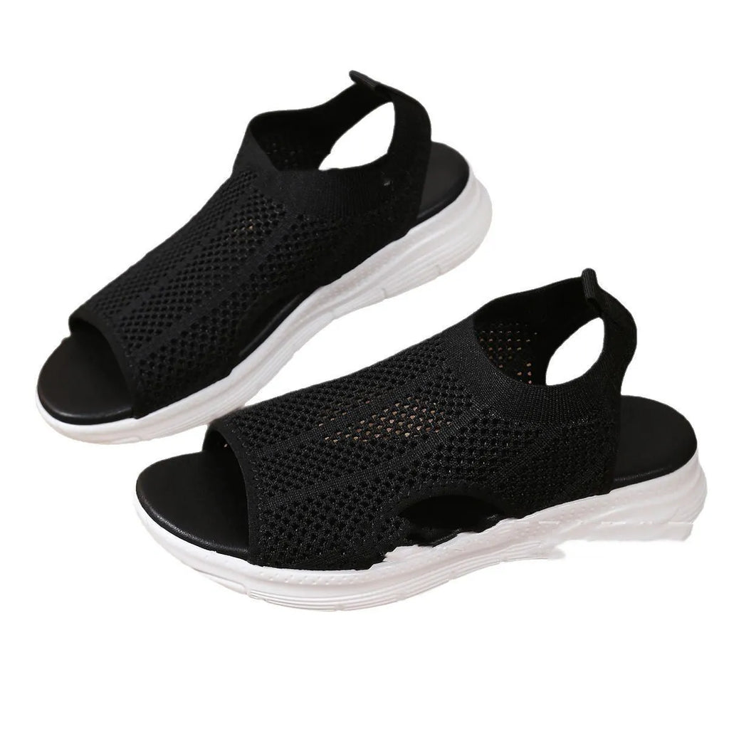 Women's flat platform sports sandals in black with a rubber sole and mesh lining.