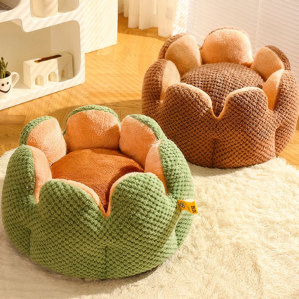 Green cactus petal-shaped soft plush pet bed for cat or dog on a hardwood floor.