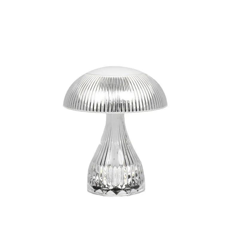 Small white rechargeable touch night lamp with three-colour changing light on wooden table