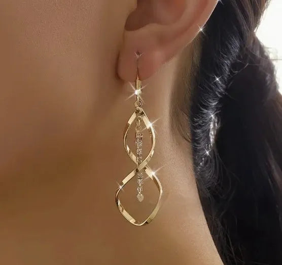 Gold geometric spiral earrings with ellipse elements creating diamond shape design