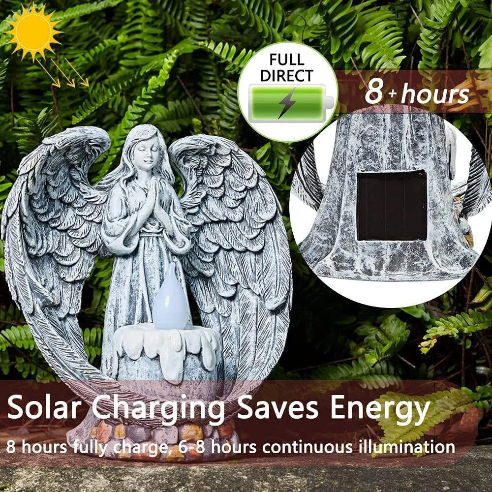 Grey resin praying angel solar garden statue on grass with wings and hands clasped