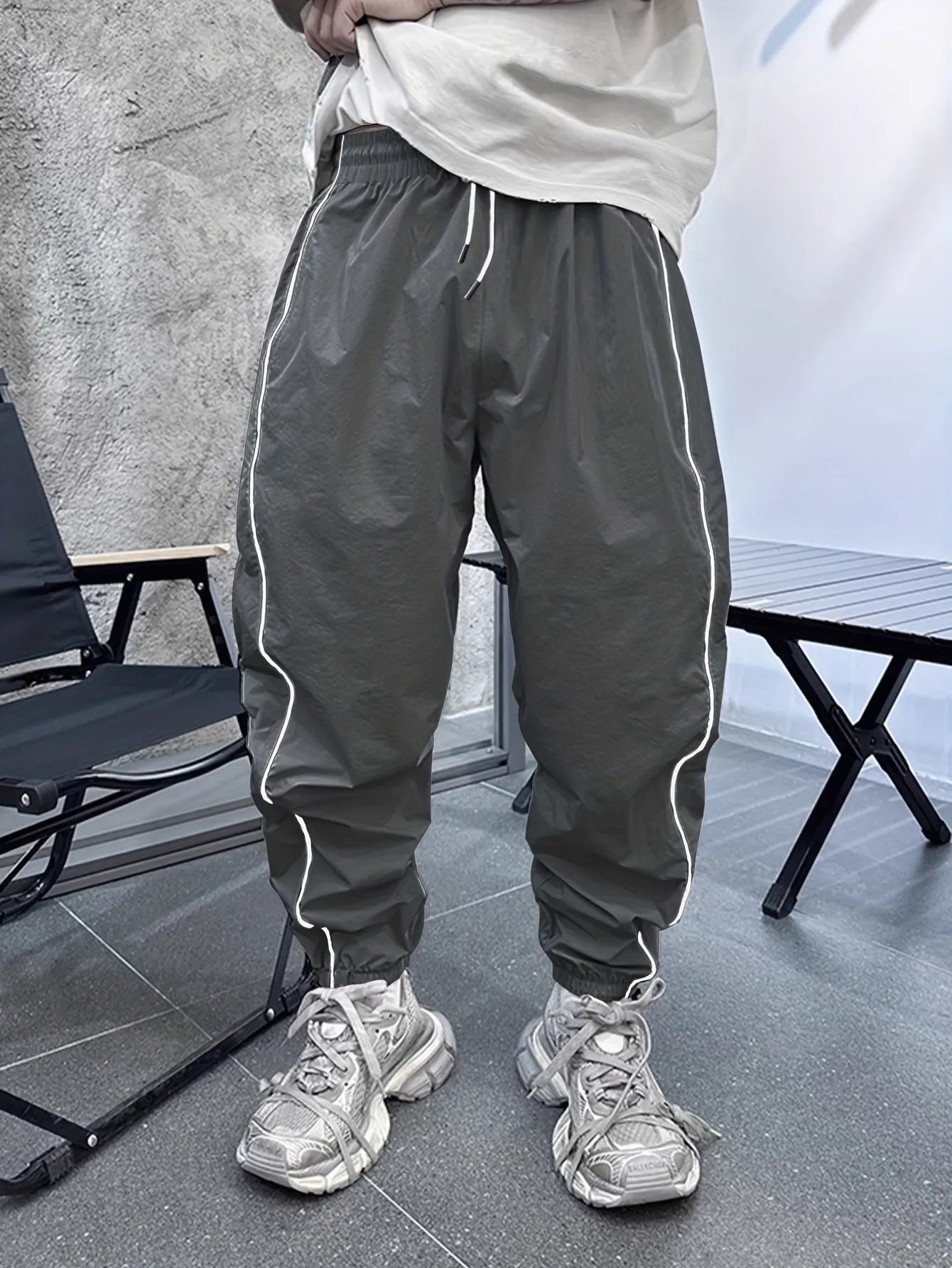 Man wearing loose-fit, cropped-length casual trousers in bamboo fibre, shown in khaki colour
