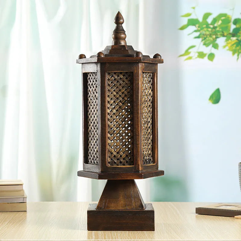 Retro wood table lamp with hand-woven straw rattan lampshade on a desk
