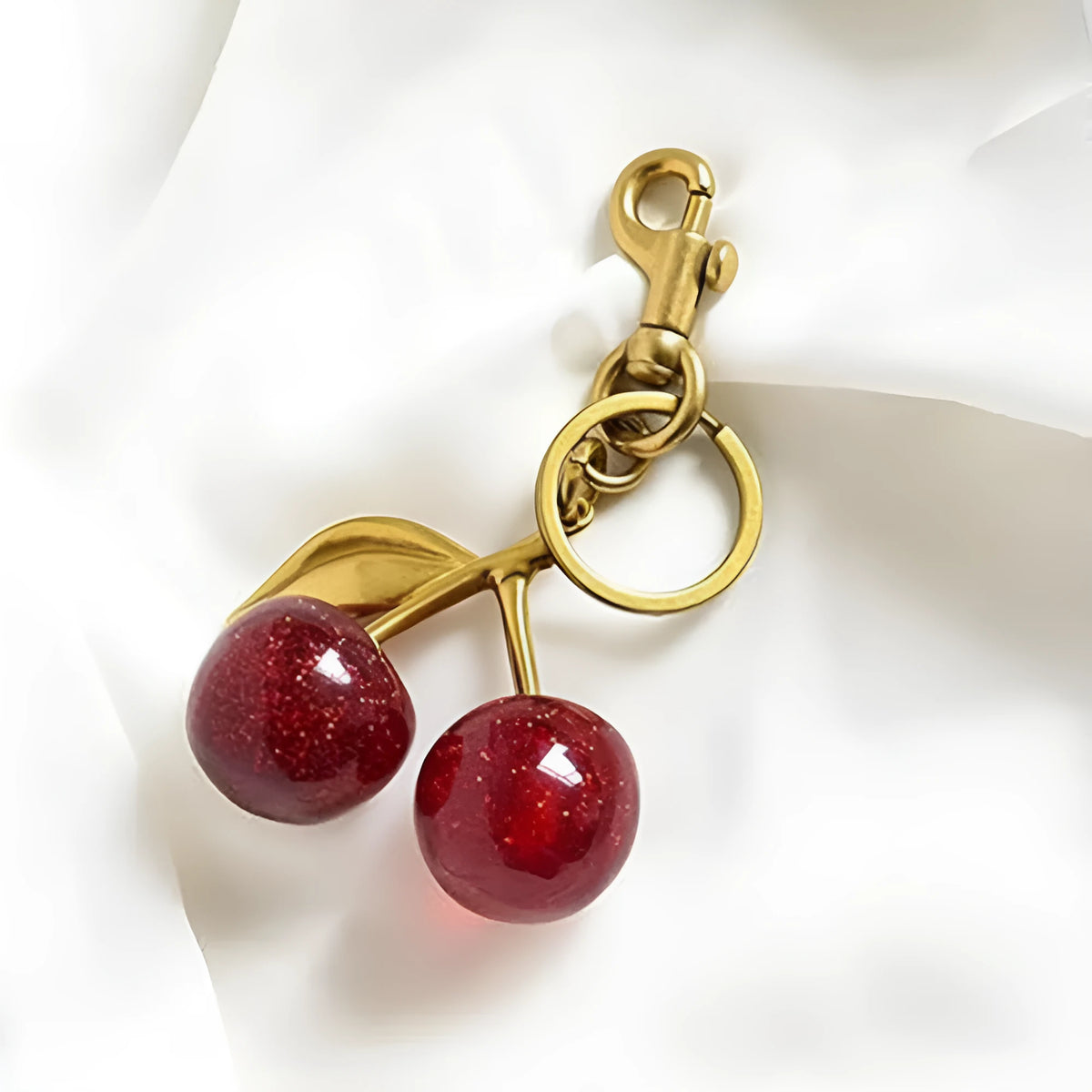 Red zinc alloy keychain with three-dimensional cherry pendant design for car keys and handbags