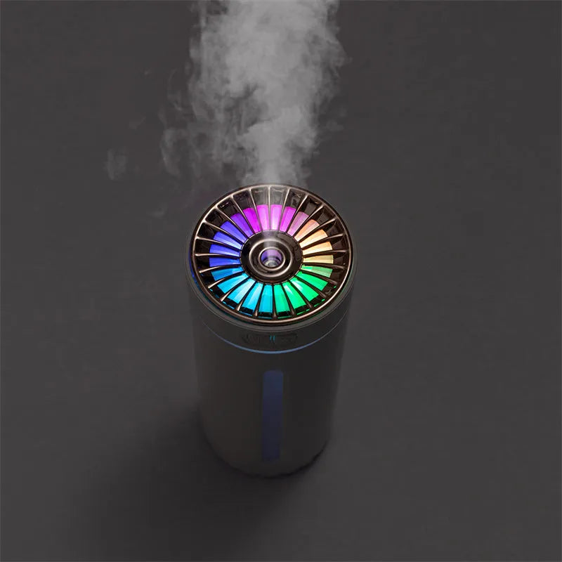 Black and white portable wireless humidifier with LED lights on a car cup holder and desktop