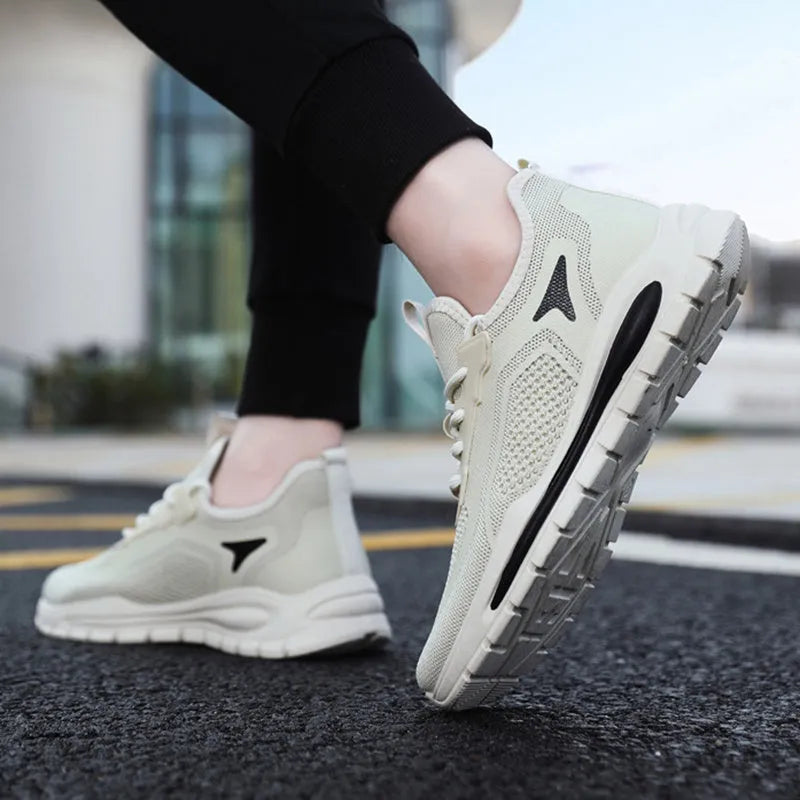 Men's fly knit mesh sneakers with front lace-up, flat rubber sole, round toe, and sequin detail, in beige